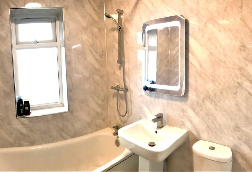 This modern bathroom features a stylish design ...