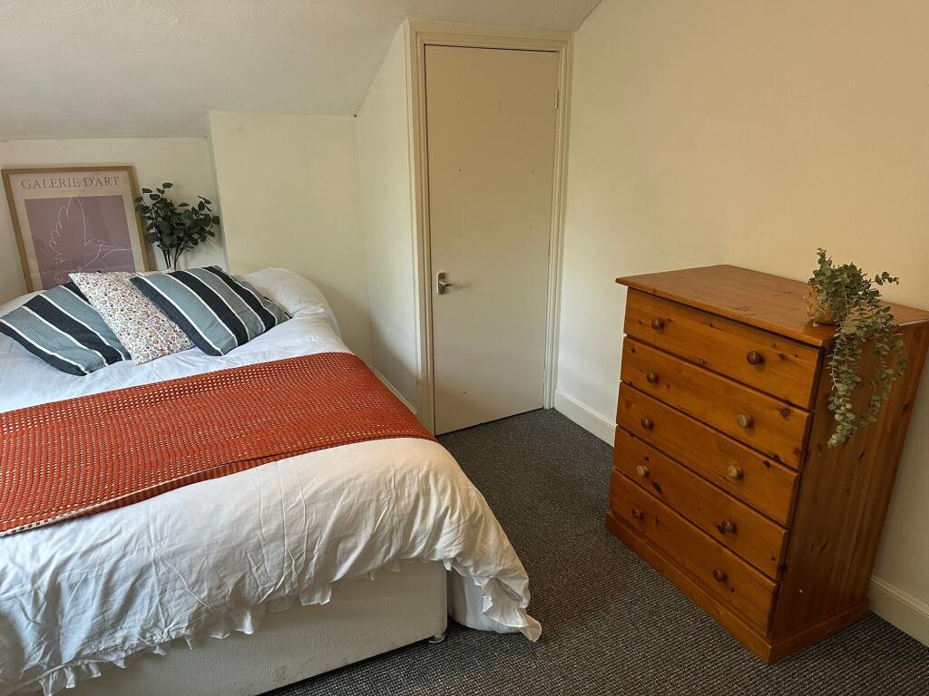 Cozy and inviting double bedroom featuring a co...