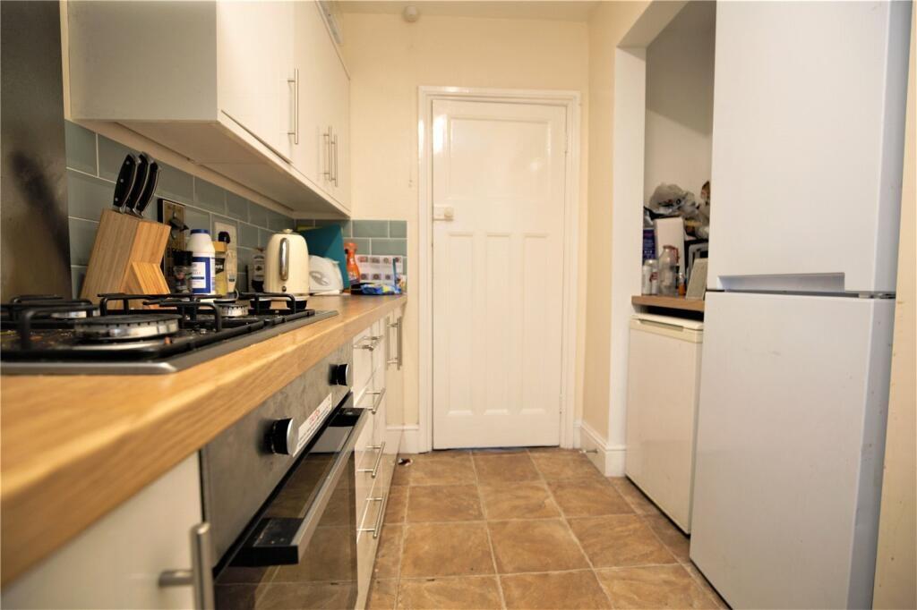 A modern kitchen with clean countertops, built-...