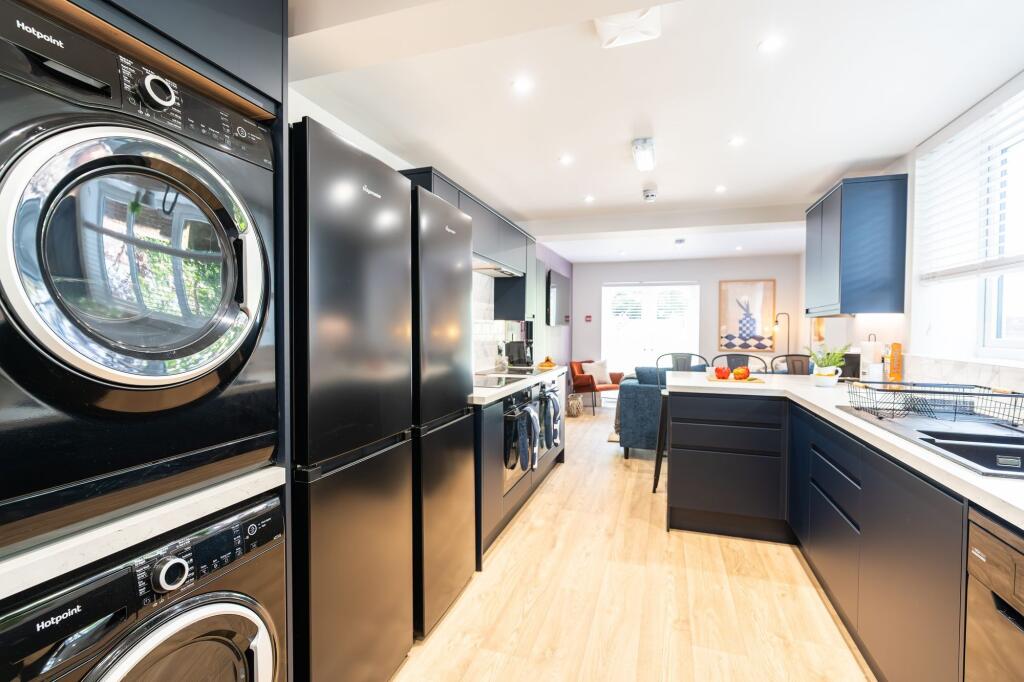 Modern and stylish kitchen featuring sleek dark...