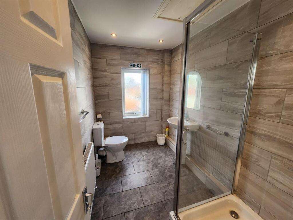 A clean and modern bathroom with a large bath a...