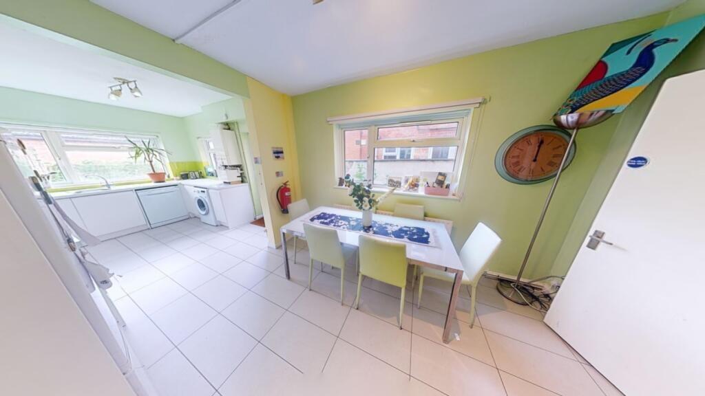 A bright and modern kitchen area featuring a di...
