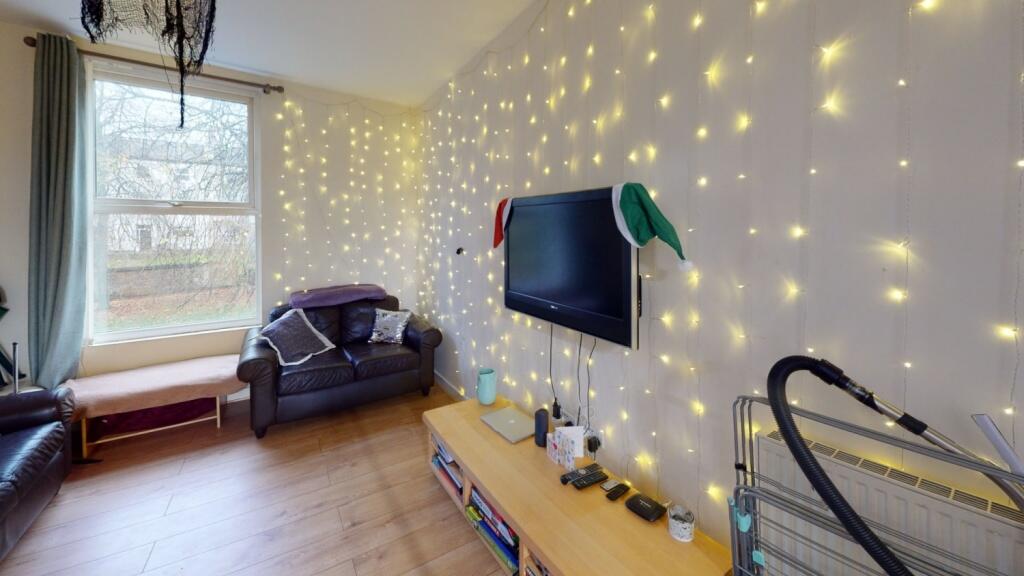 A cozy living room featuring a comfortable armc...