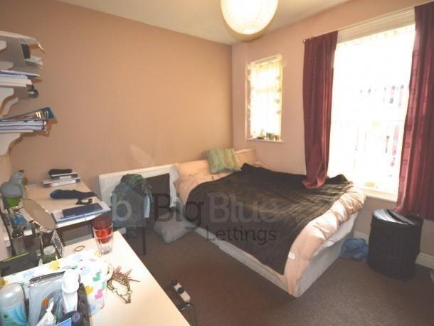 Cozy double bedroom featuring a comfortable dou...