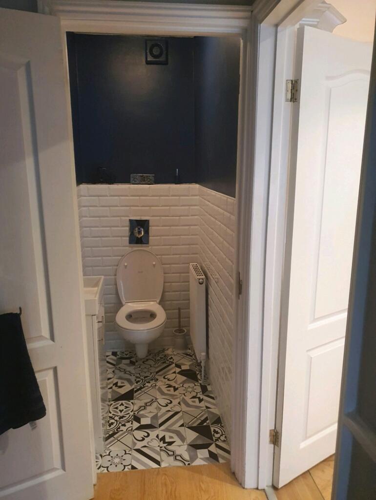 A stylishly designed single toilet with modern ...