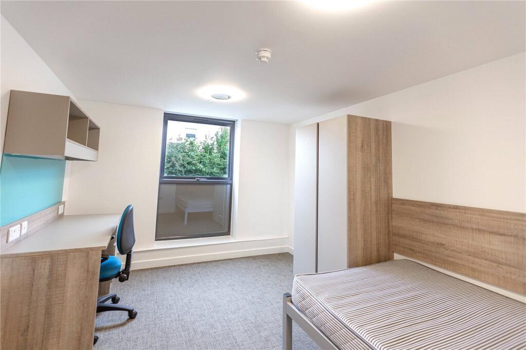 A neat and bright single bedroom featuring a co...