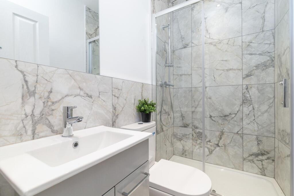 Modern, clean bathroom with a spacious shower a...