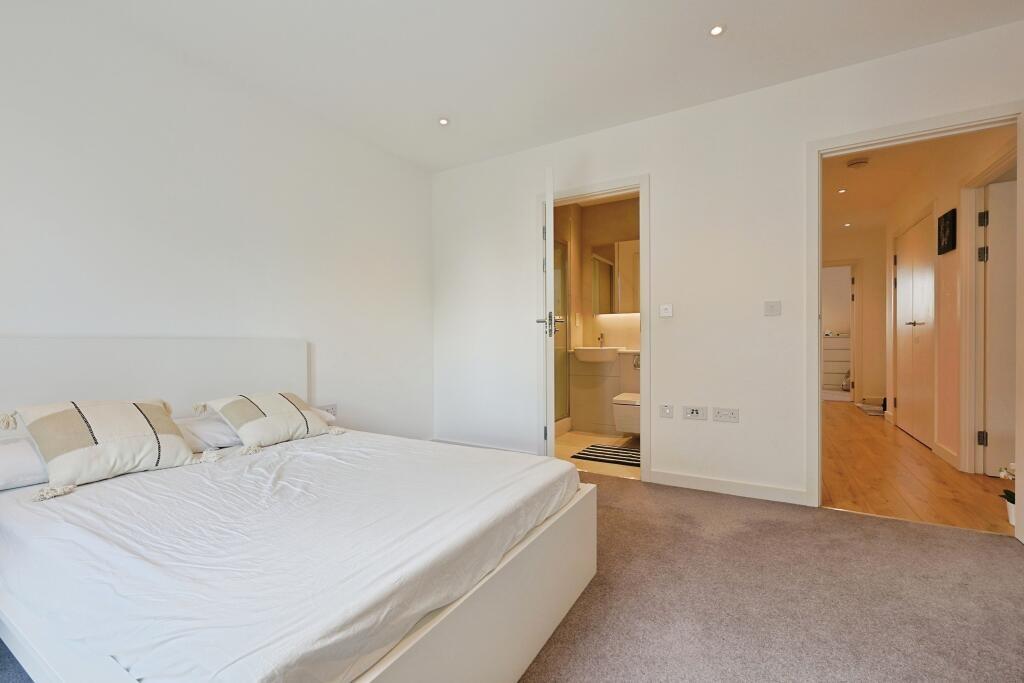 Bright and spacious master bedroom featuring a ...