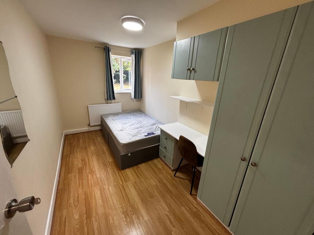 A cozy single bedroom featuring a mattress, bui...