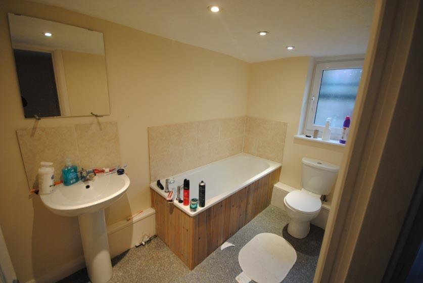 A well-maintained bathroom with a large bath an...