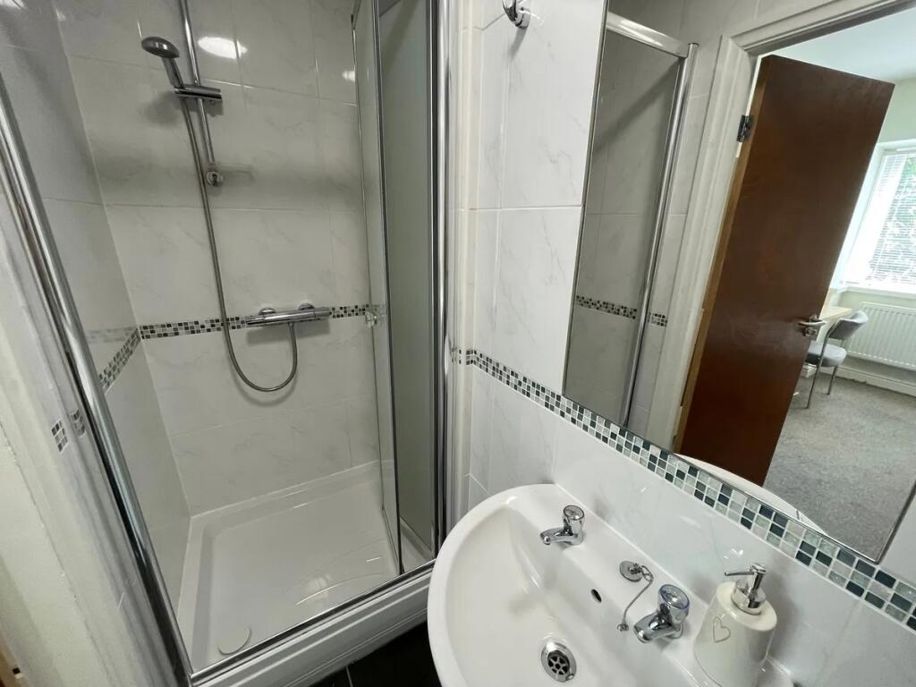 Bright and clean bathroom featuring a modern wa...