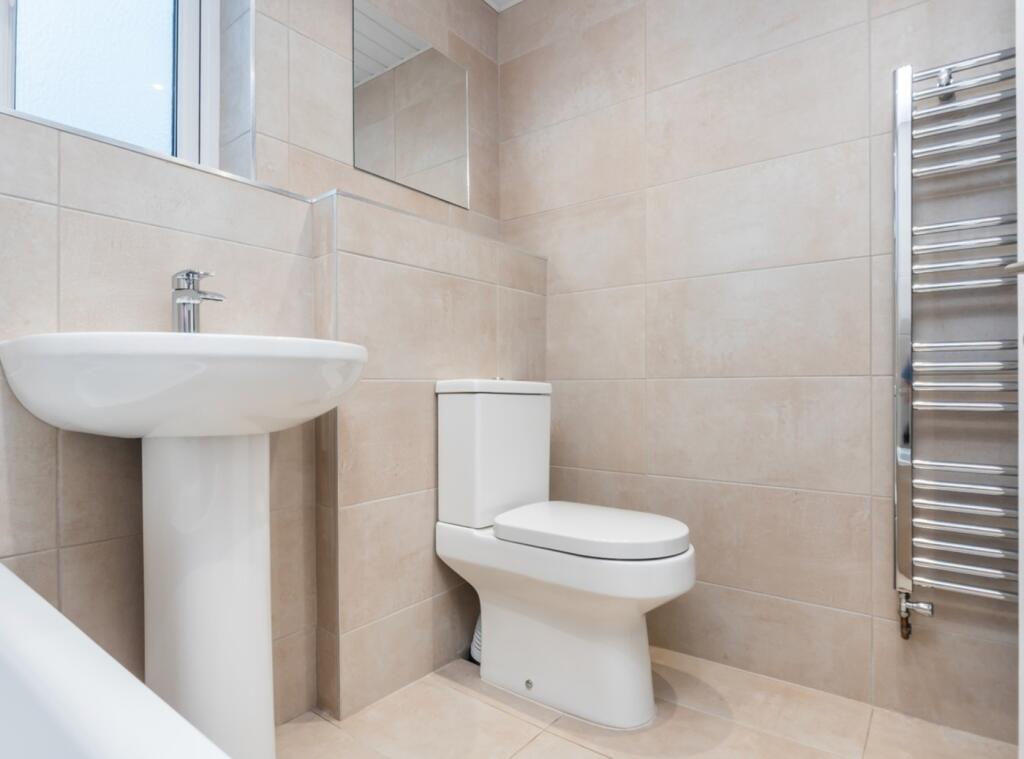 A modern and pristine bathroom featuring elegan...