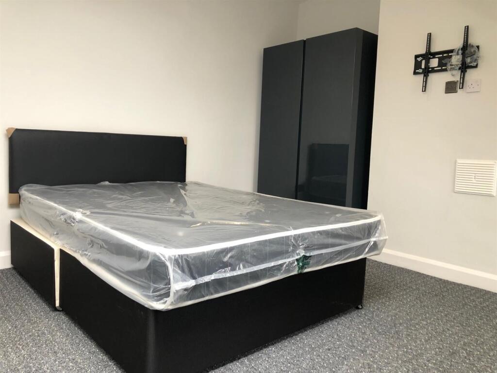 A neatly presented single bedroom featuring a c...