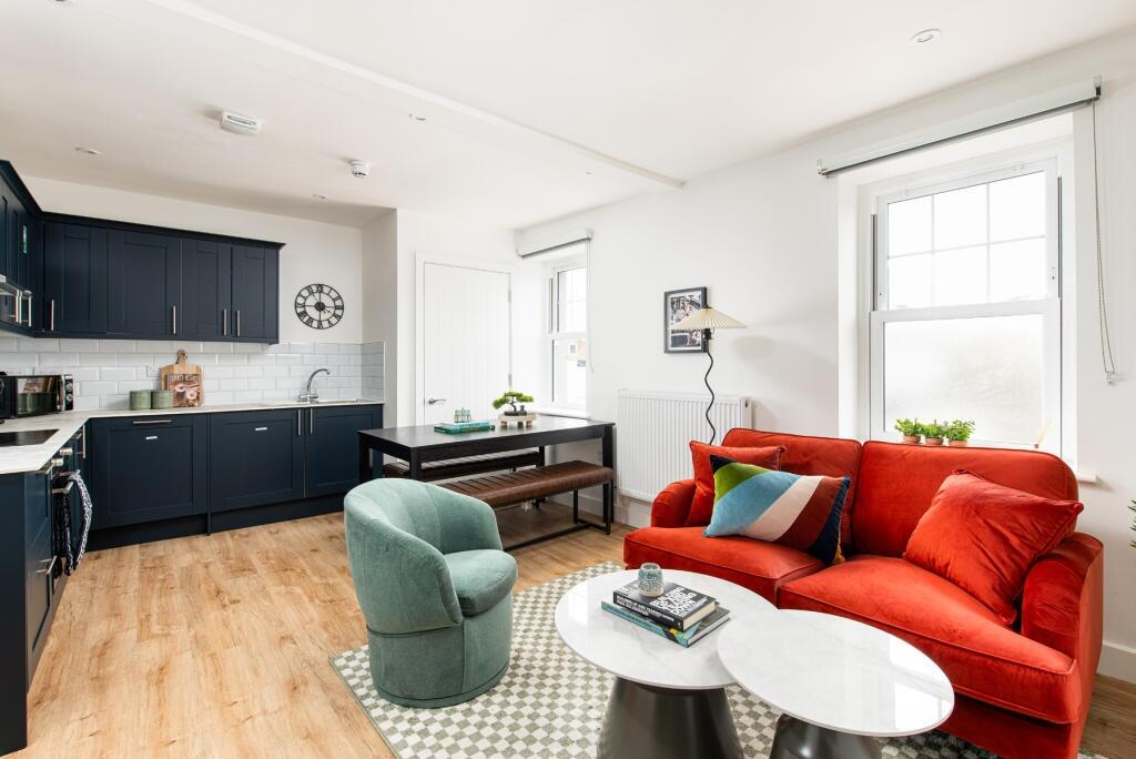 Bright and stylish living room featuring a vibr...