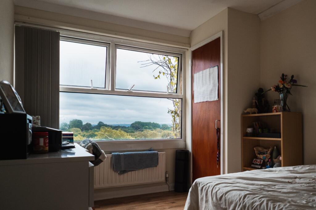 A bright and inviting double bedroom with a vie...