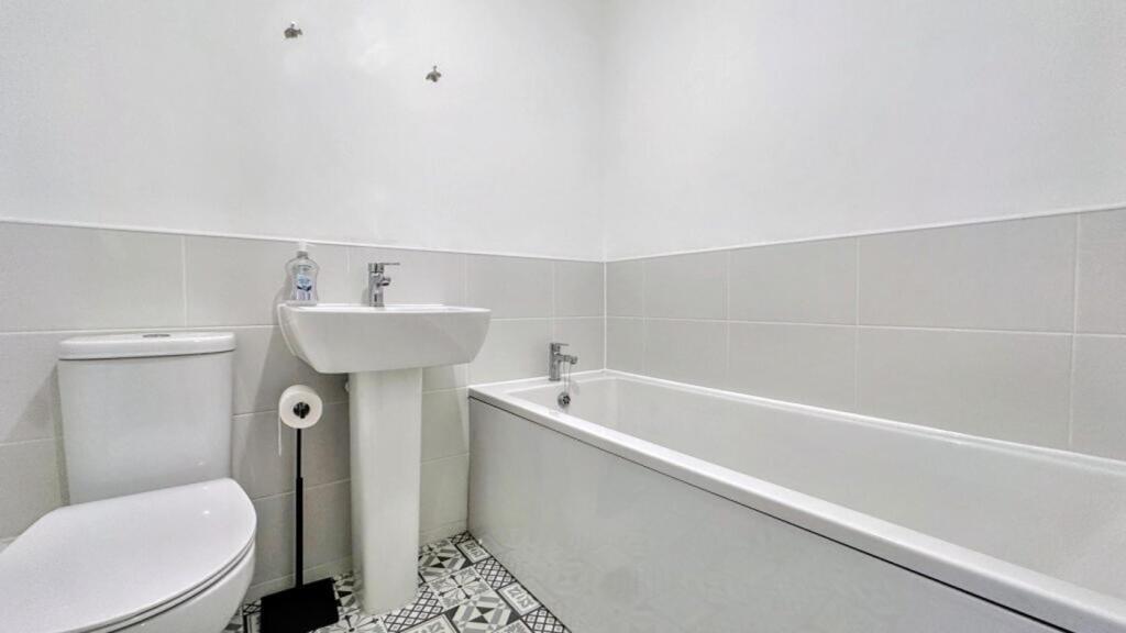 A modern bathroom featuring a sleek design with...