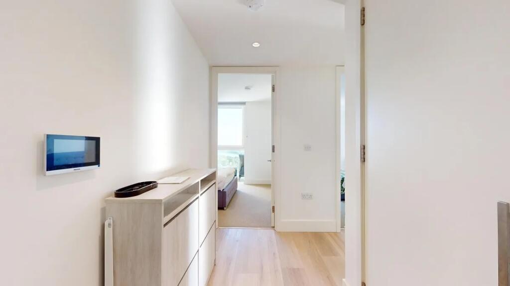 Bright and modern hallway featuring light wood ...