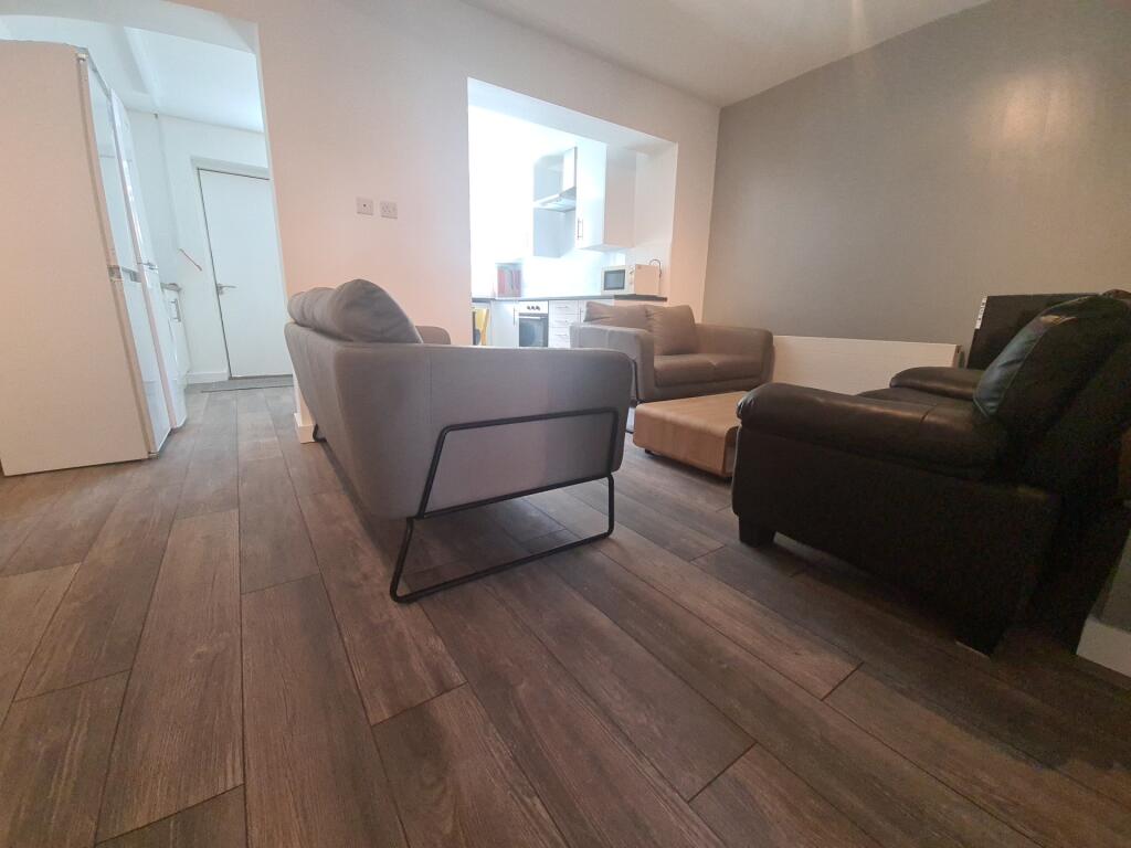 A cozy living room featuring modern sofas and w...