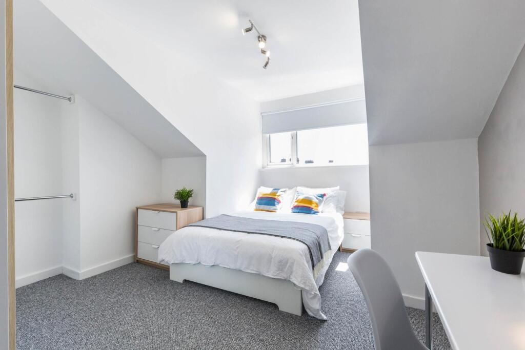 Bright and modern master bedroom featuring a sp...