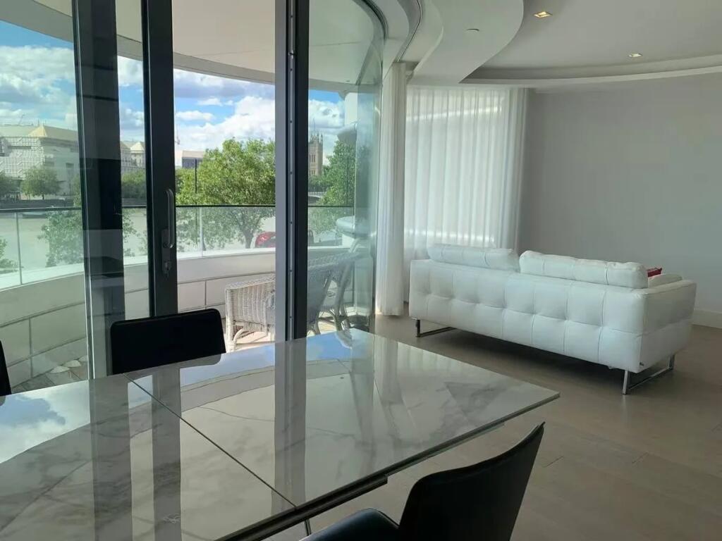 A modern living room featuring a sleek white so...