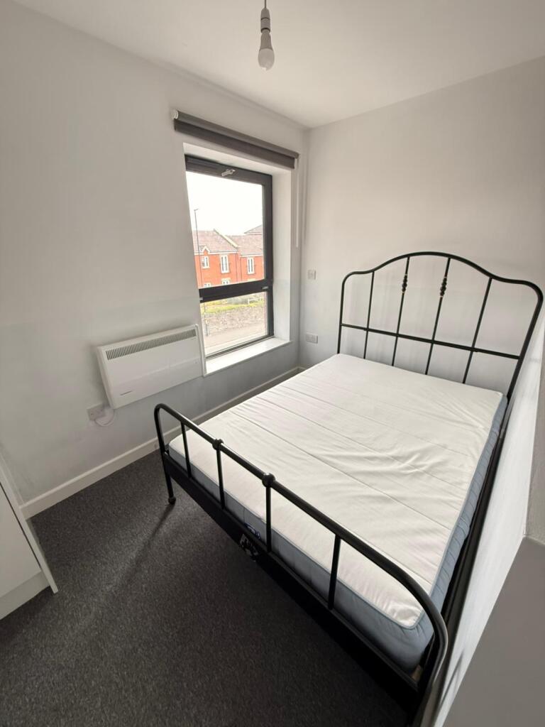 Cozy double bedroom featuring a stylish black m...