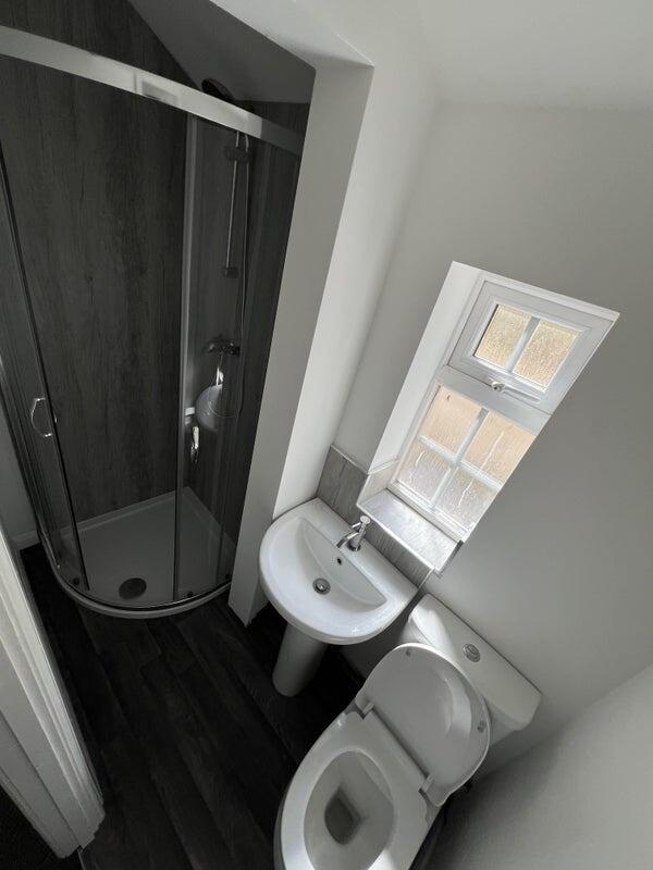 Compact and clean bathroom featuring a modern c...