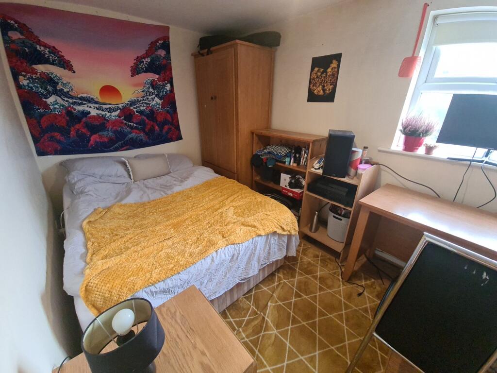 Cozy single bedroom featuring a comfortable bed...