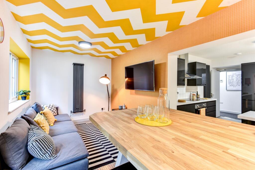 This vibrant living room features a stylish des...