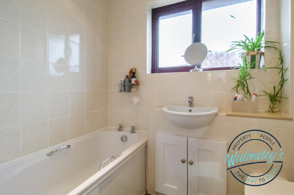 Bathroom with mains shower above bath