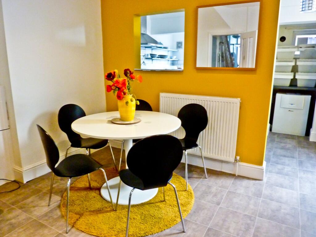 A stylish kitchen area featuring a round dining...