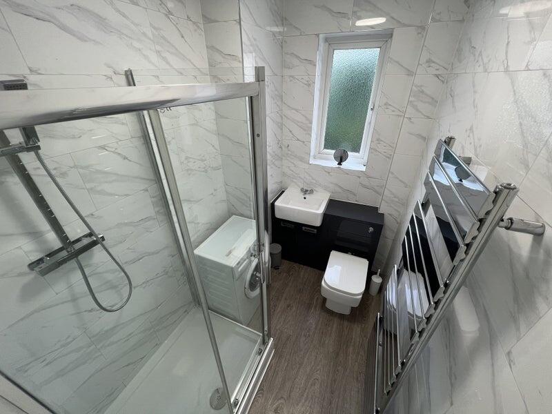 Bright and modern bathroom suite featuring a sp...