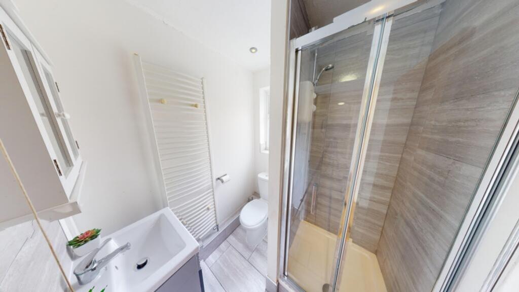 A clean and modern bathroom featuring a spaciou...