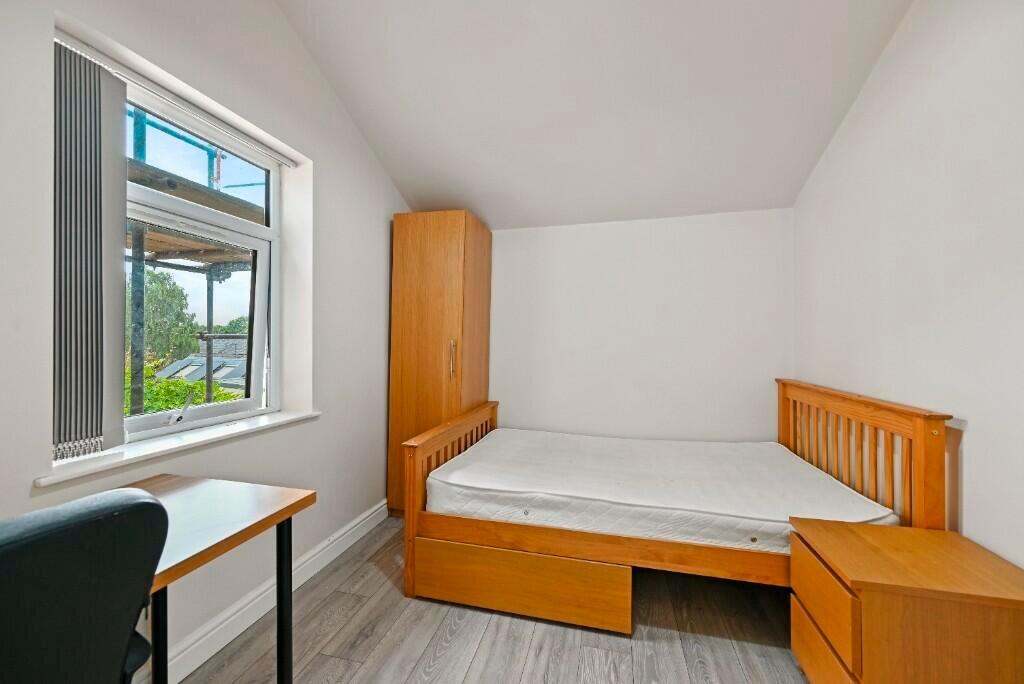 Bright and tidy single bedroom featuring a wood...