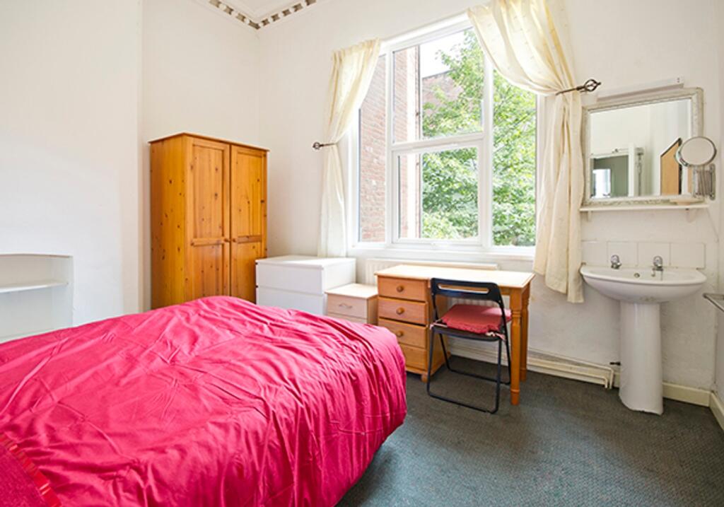 A bright and inviting double bedroom with ample...