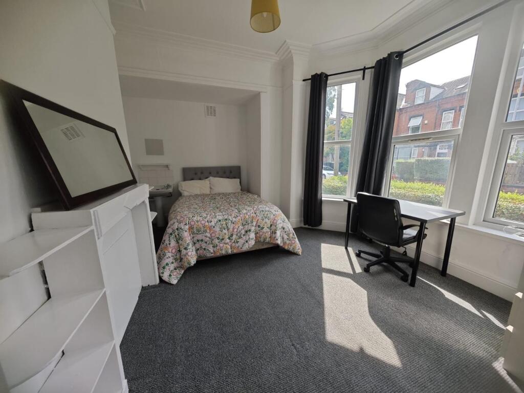 A bright and airy double bedroom featuring a co...