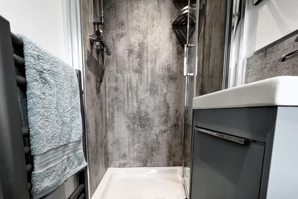Modern bathroom featuring a sleek walk-in showe...