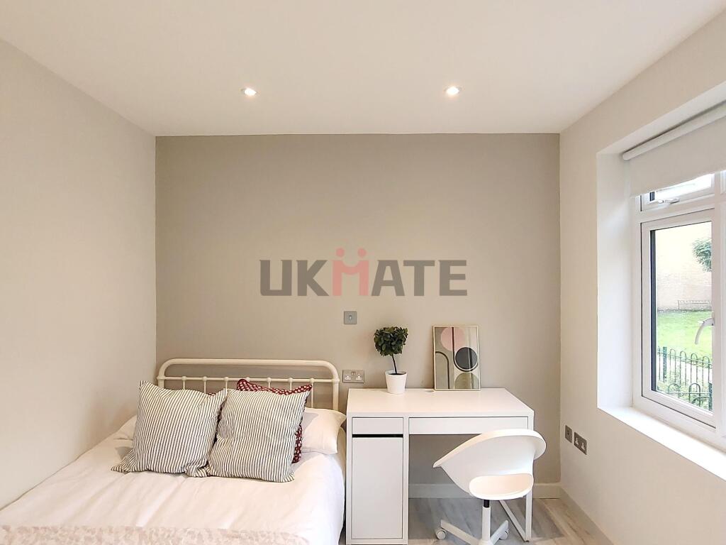 A bright and inviting single bedroom featuring ...