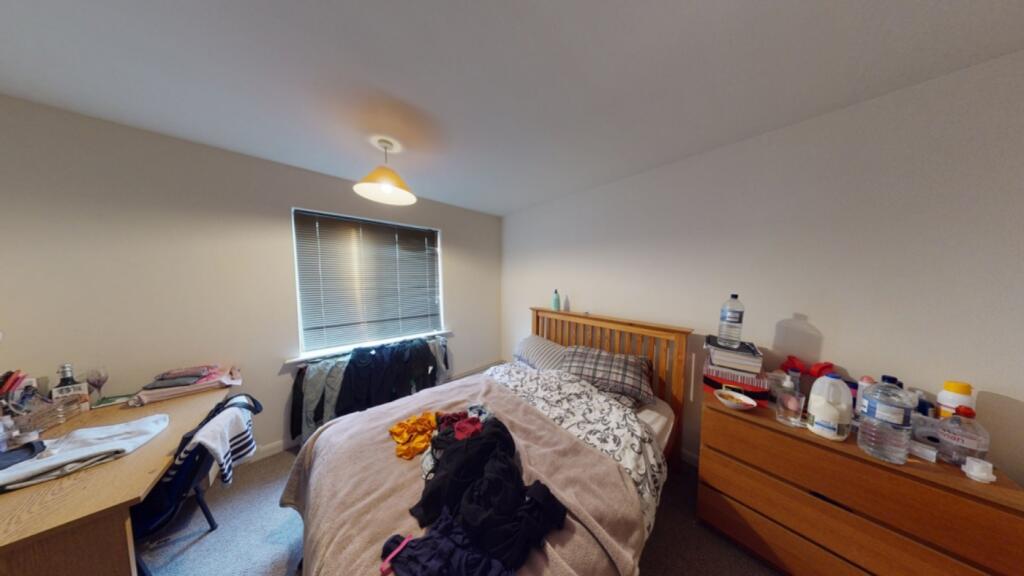 A spacious double bedroom with ample natural li...