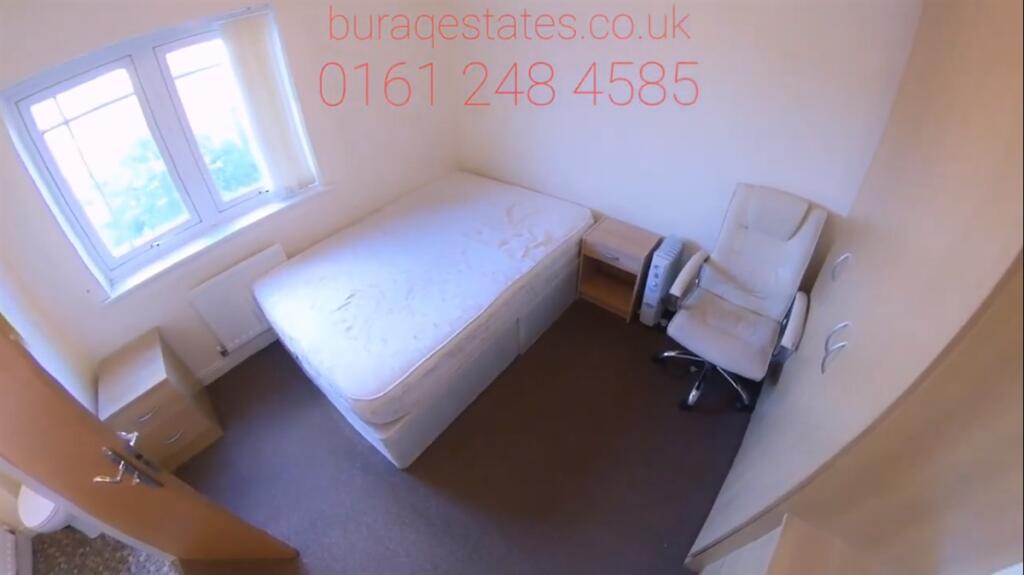 Bright, simply furnished bedroom with a comfort...