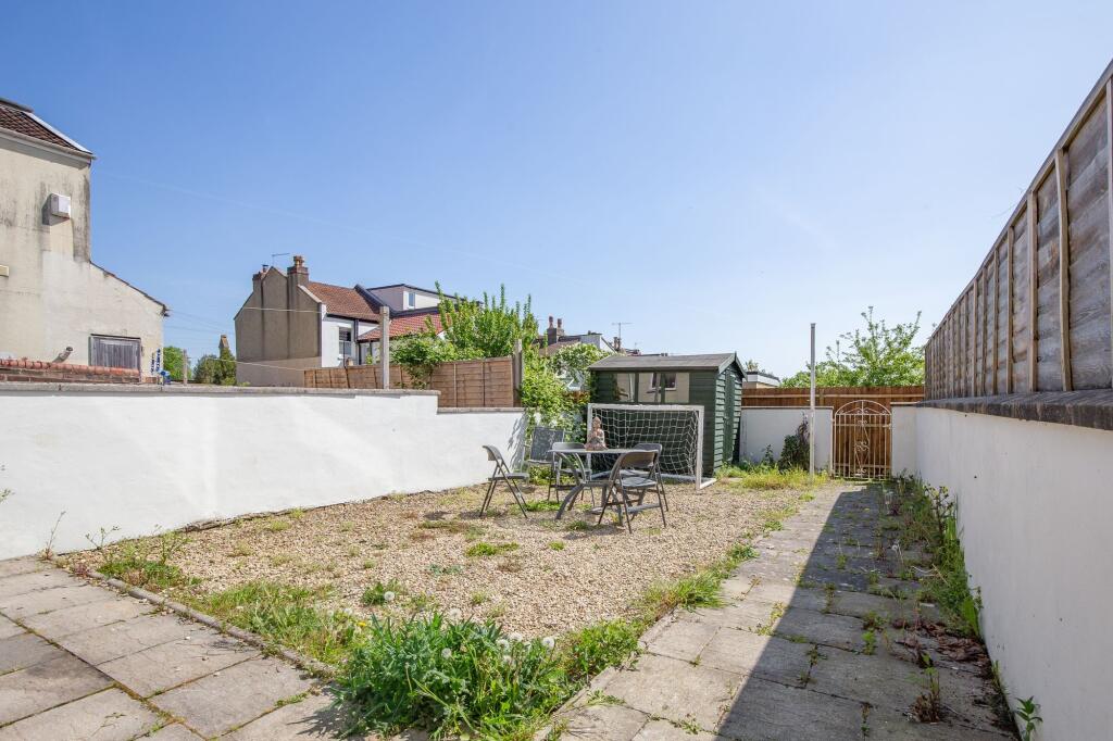 Bright and open garden space featuring a gravel...