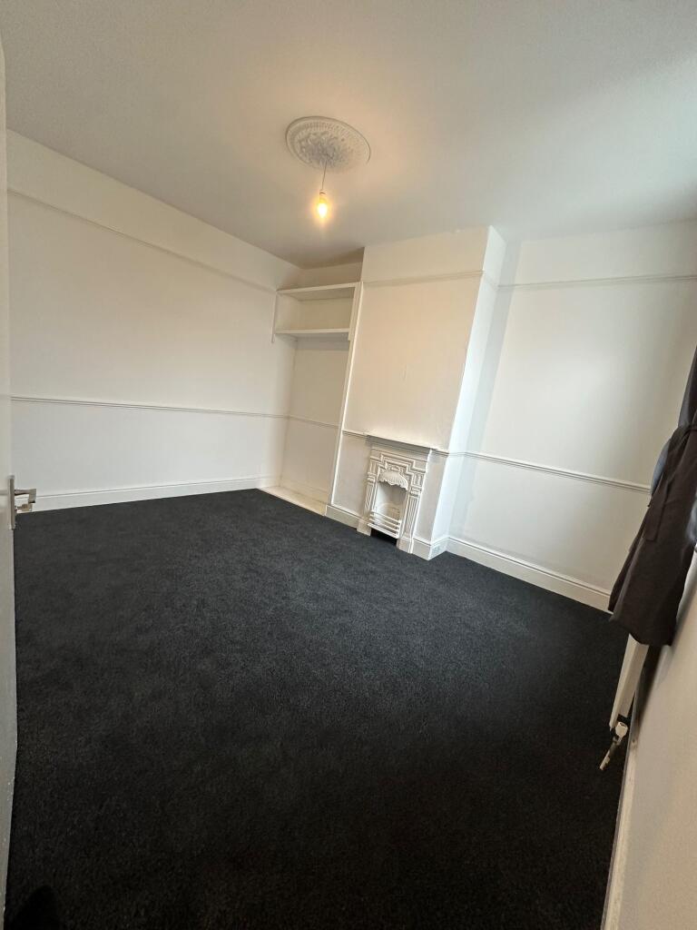 A clean, simple double bedroom featuring fresh ...