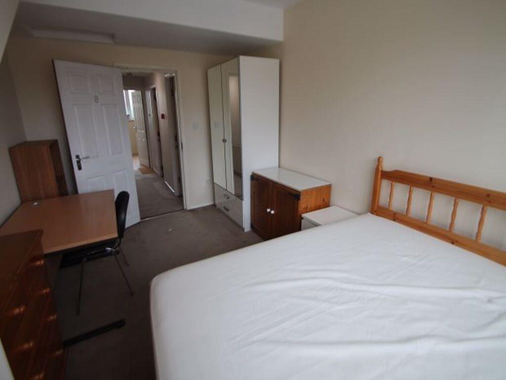 Bright and neatly arranged double bedroom featu...