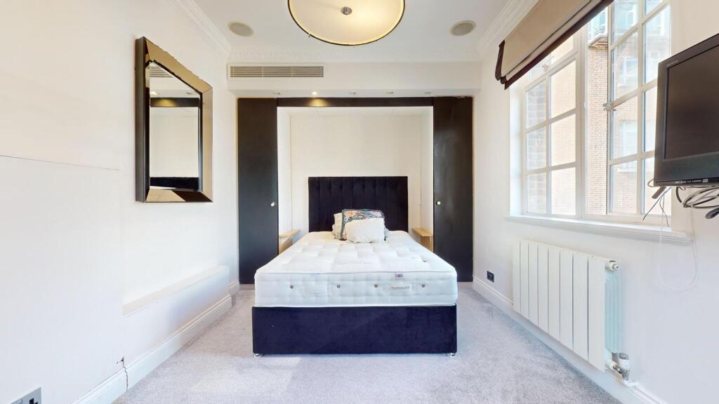 A bright and neat single bedroom featuring a co...