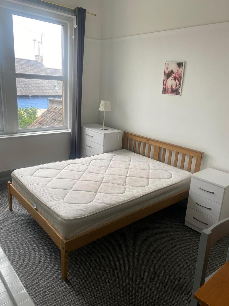 A bright and tidy double bedroom featuring a wo...