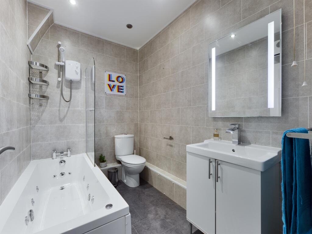 A modern and spacious bathroom featuring a luxu...