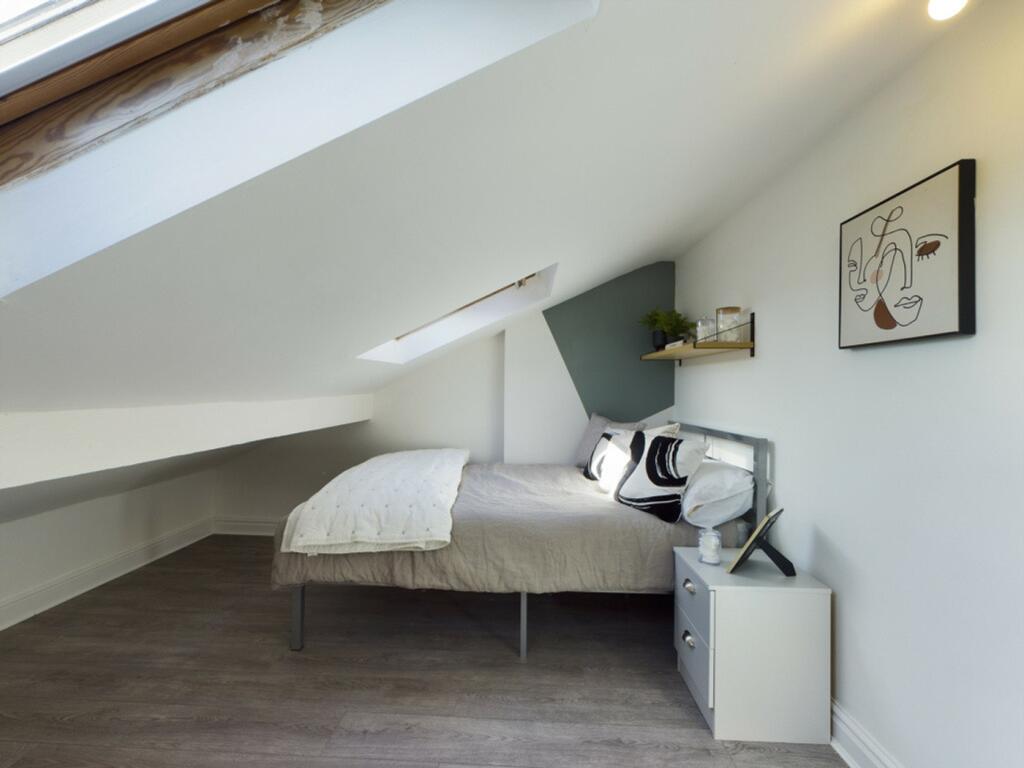 A stylish and cozy double bedroom featuring nat...