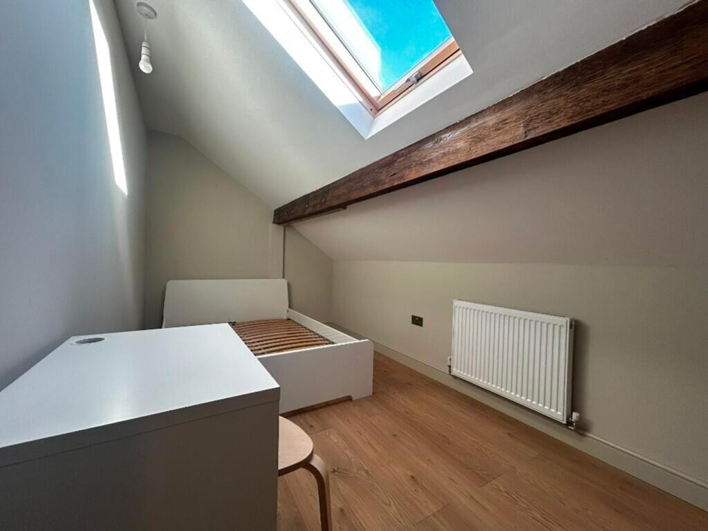A bright and inviting double bedroom with moder...