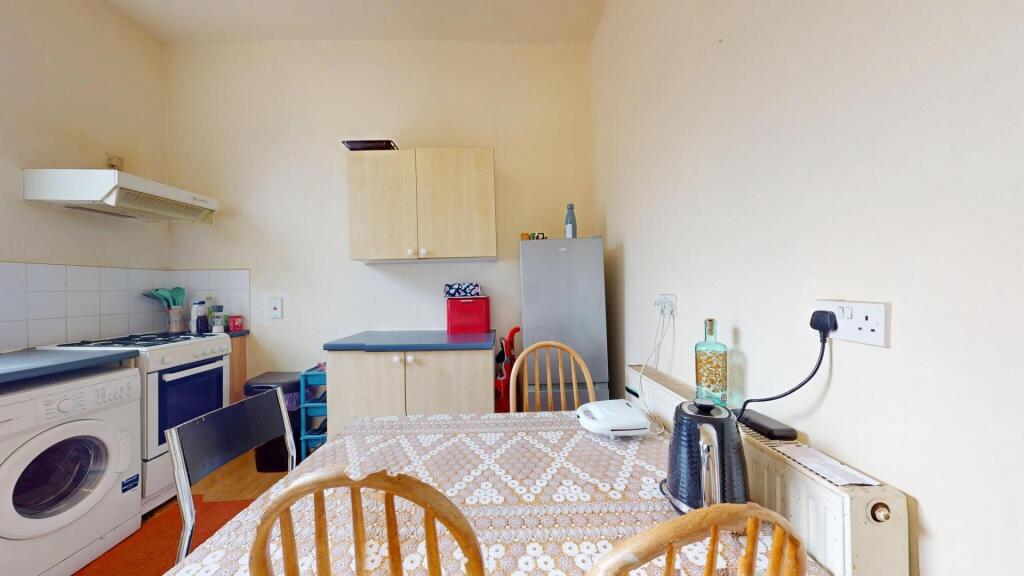 A bright and tidy kitchen featuring a washing m...