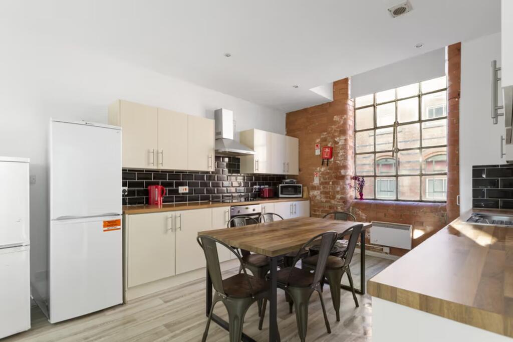 A spacious and well-lit kitchen with modern app...