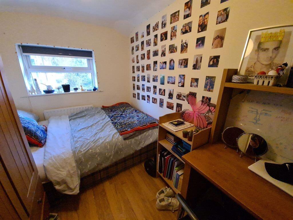 Cozy single bedroom featuring a comfortable bed...